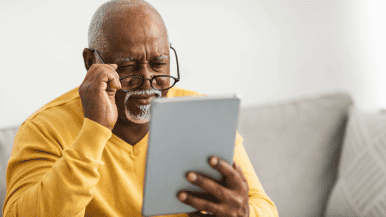 Picture of man reading ipad with glasses
